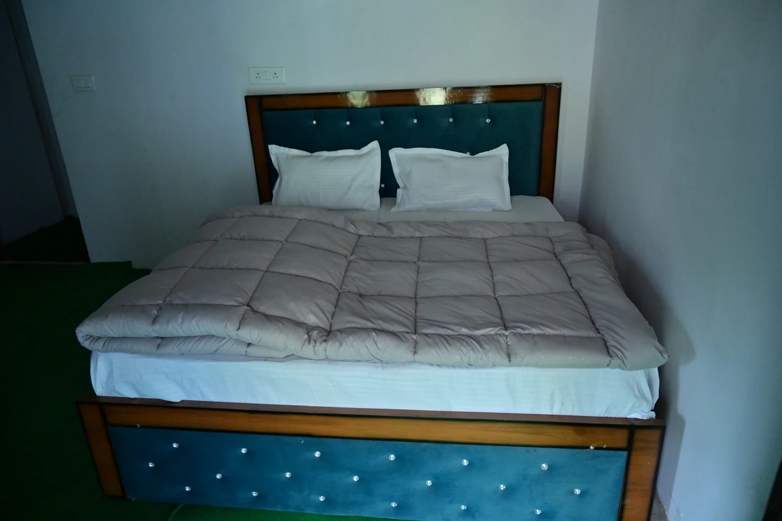 Double bed room with blue upholstered headboard